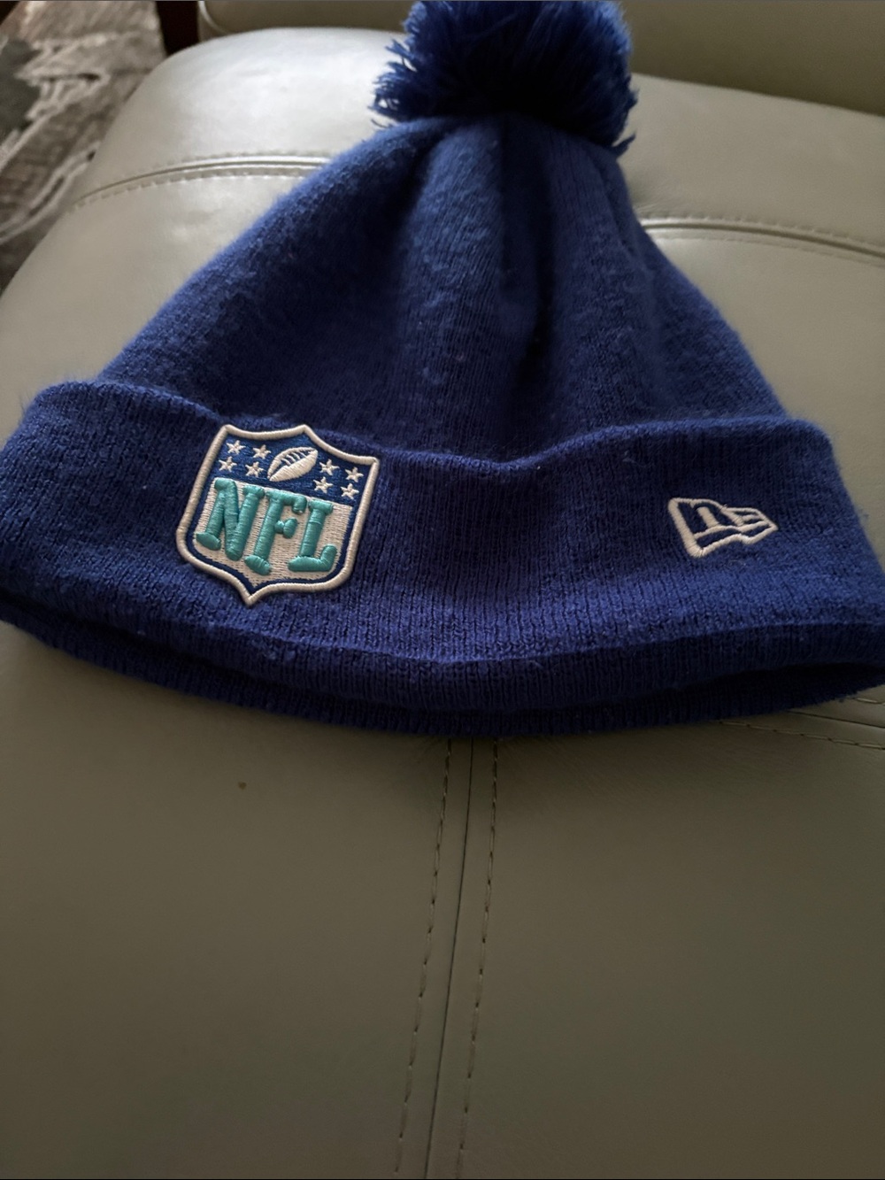 New Era Pom Beanie - Royal Blue with Teal NFL Patch